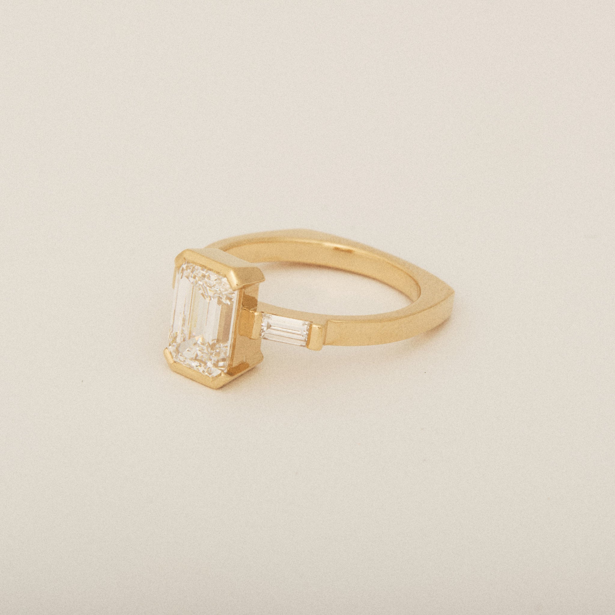 Emerald Cut Diamond Half Bezel Set with Two Baguette Sides Engagement Ring