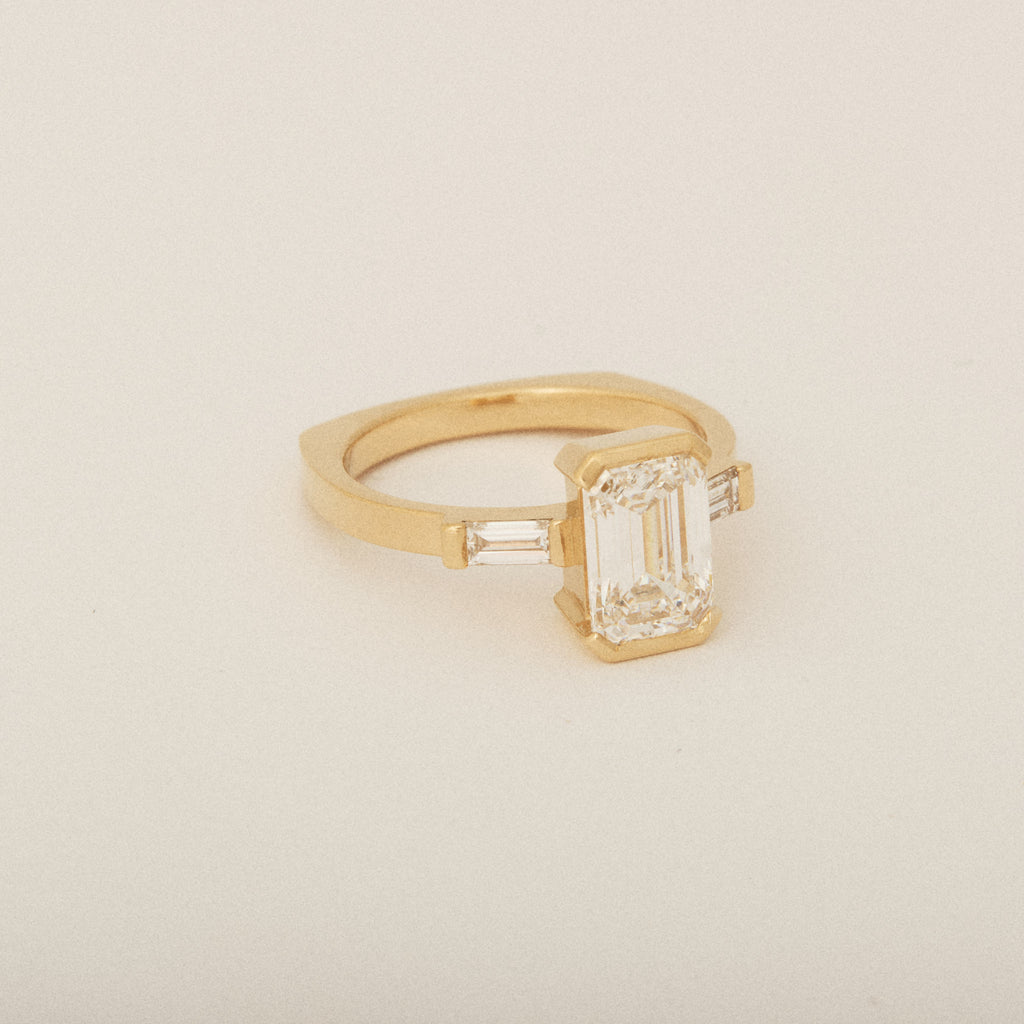 Emerald Cut Diamond Half Bezel Set with Two Baguette Sides Engagement Ring