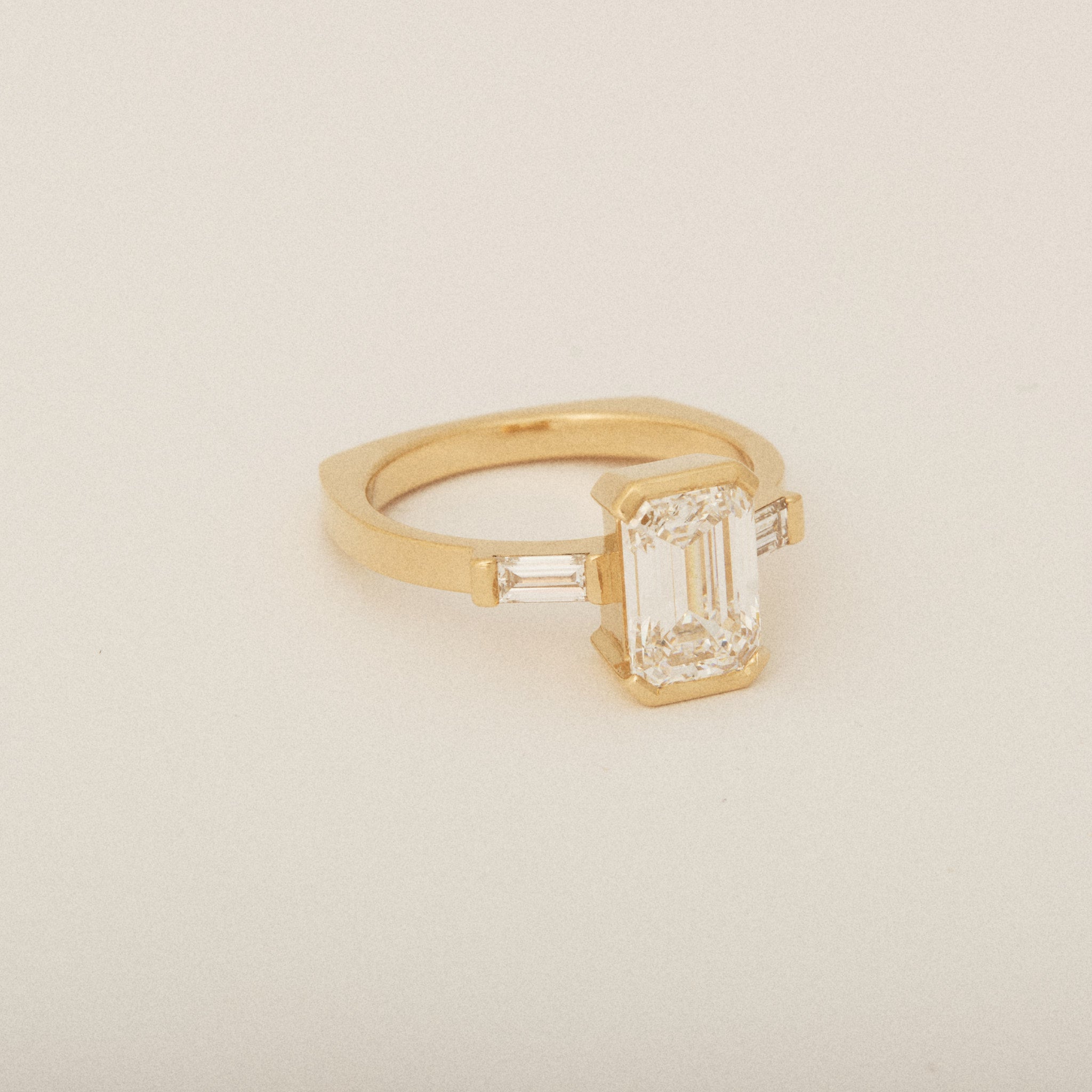 Emerald Cut Diamond Half Bezel Set with Two Baguette Sides Engagement Ring