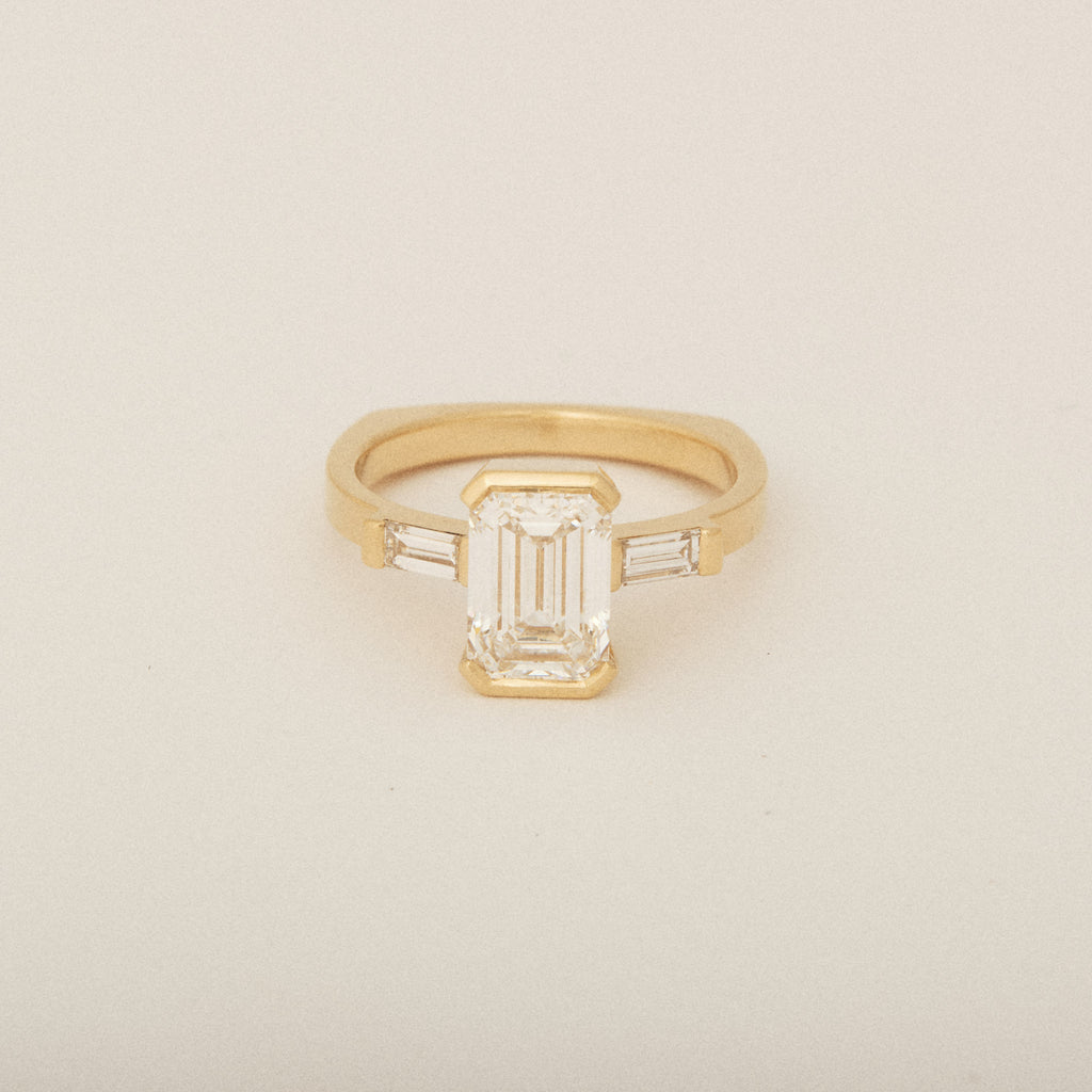 Emerald Cut Diamond Half Bezel Set with Two Baguette Sides Engagement Ring