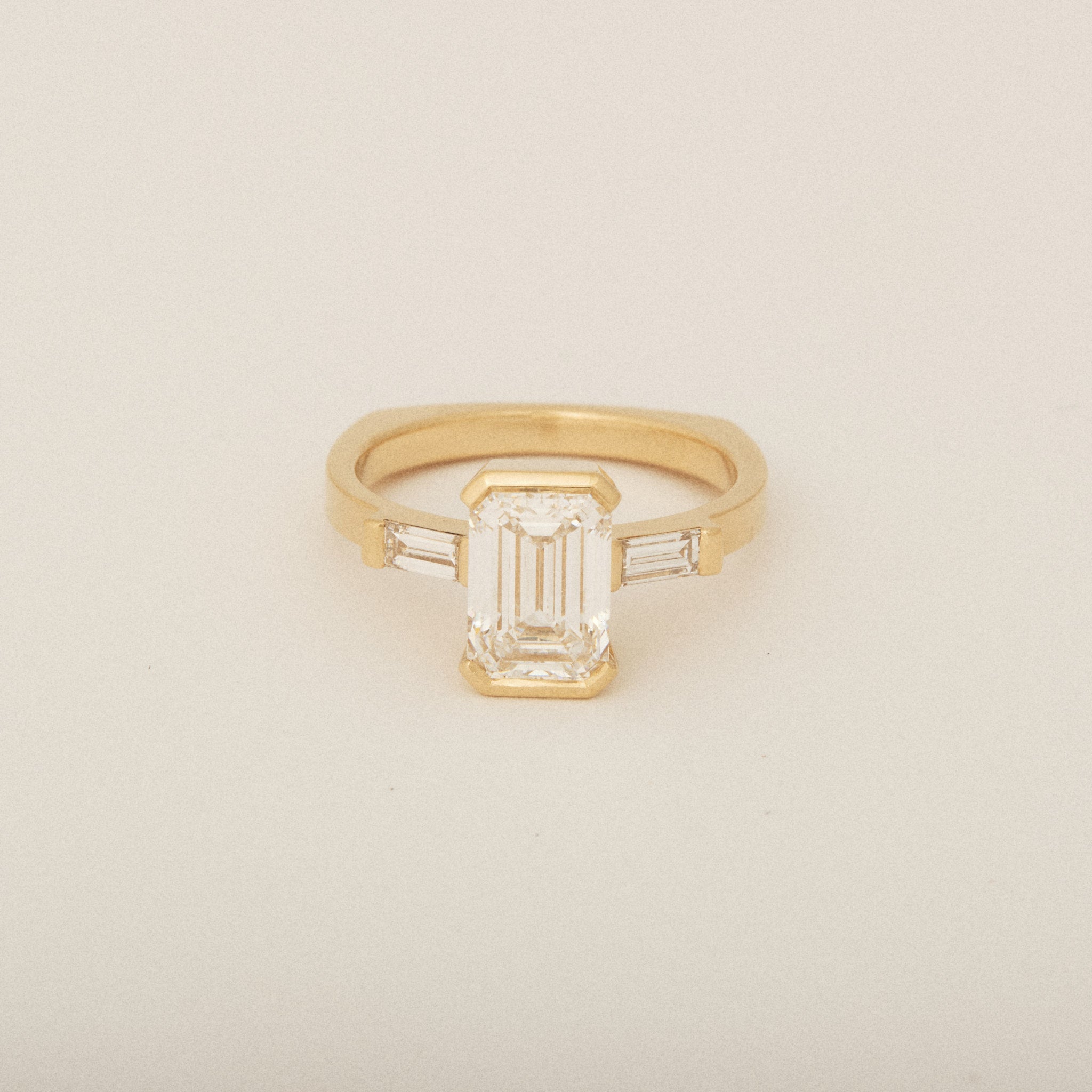 Emerald Cut Diamond Half Bezel Set with Two Baguette Sides Engagement Ring