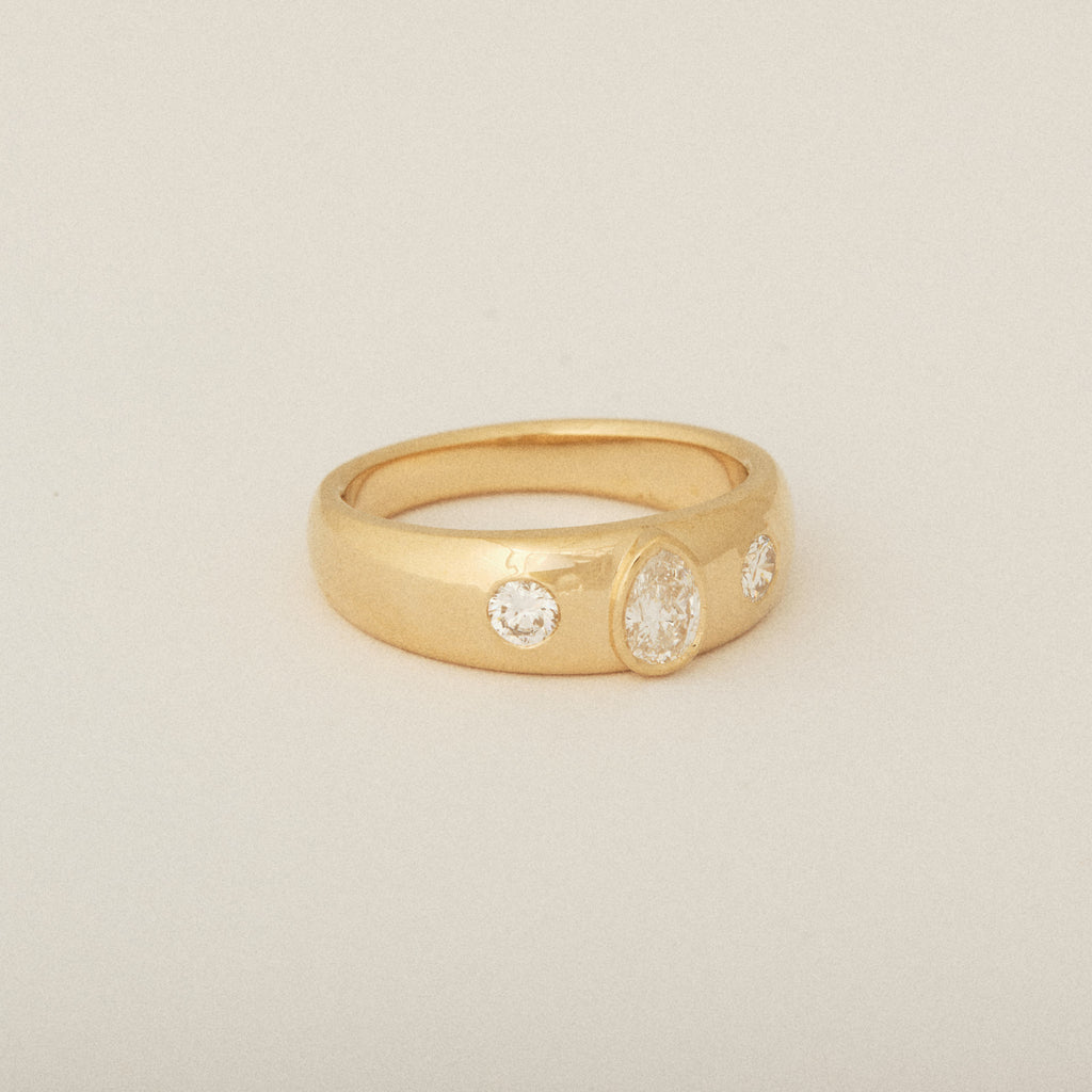 Three Heirloom Pear Shaped Diamonds in a Tapered Bezel Flush Set Engagement Ring