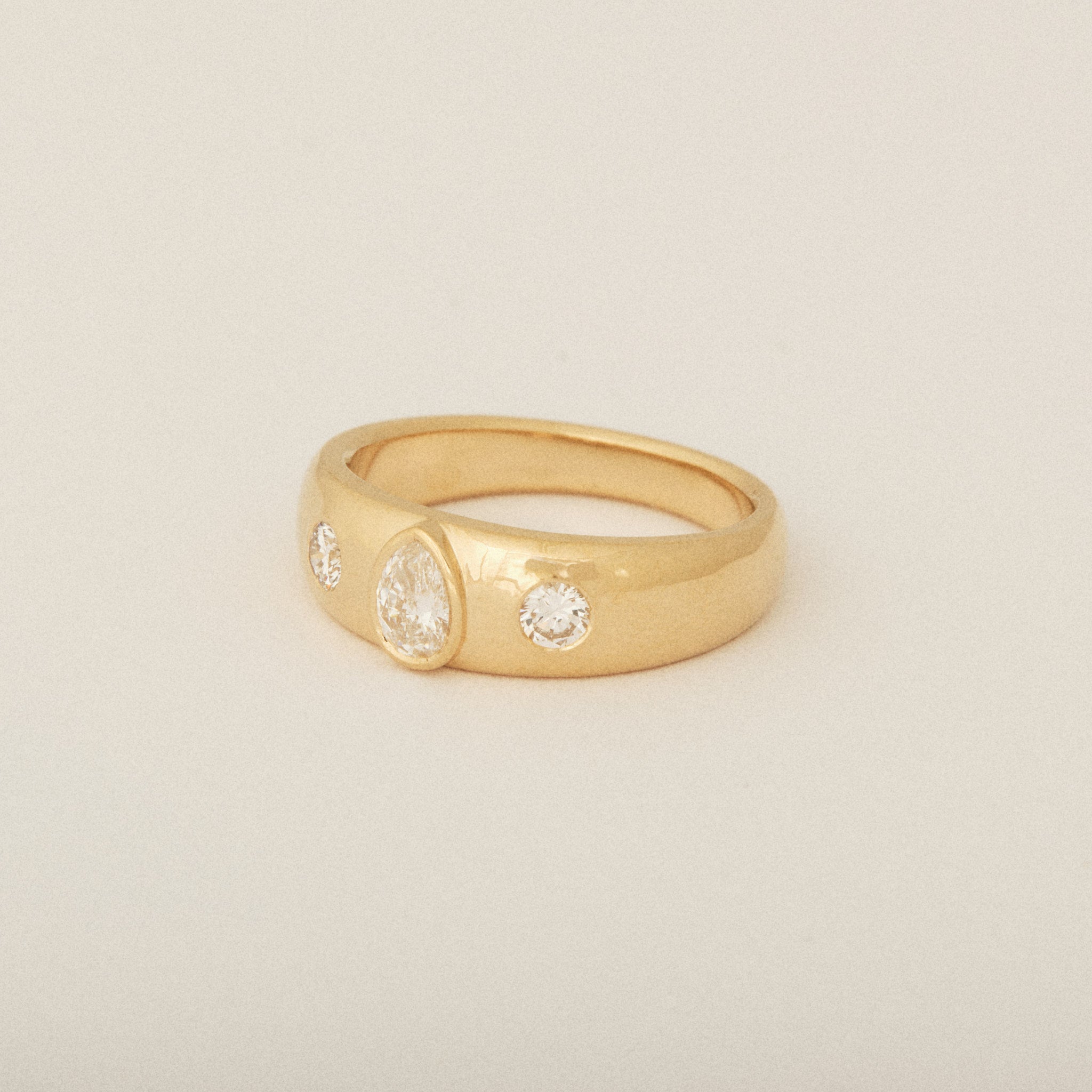 Three Heirloom Pear Shaped Diamonds in a Tapered Bezel Flush Set Engagement Ring