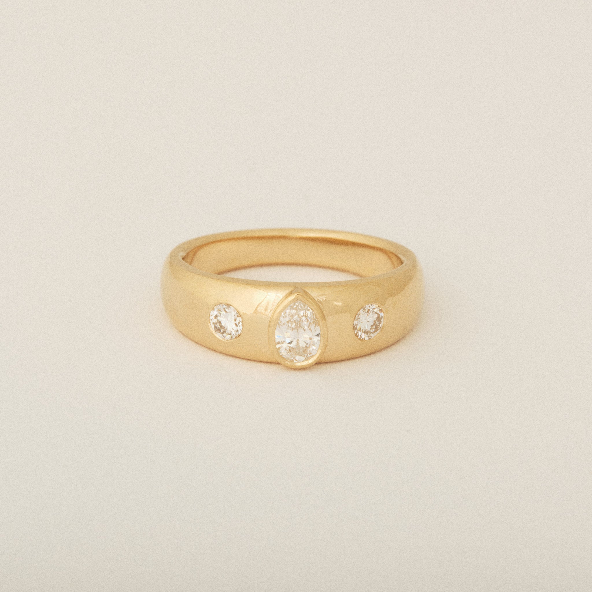 Three Heirloom Pear Shaped Diamonds in a Tapered Bezel Flush Set Engagement Ring