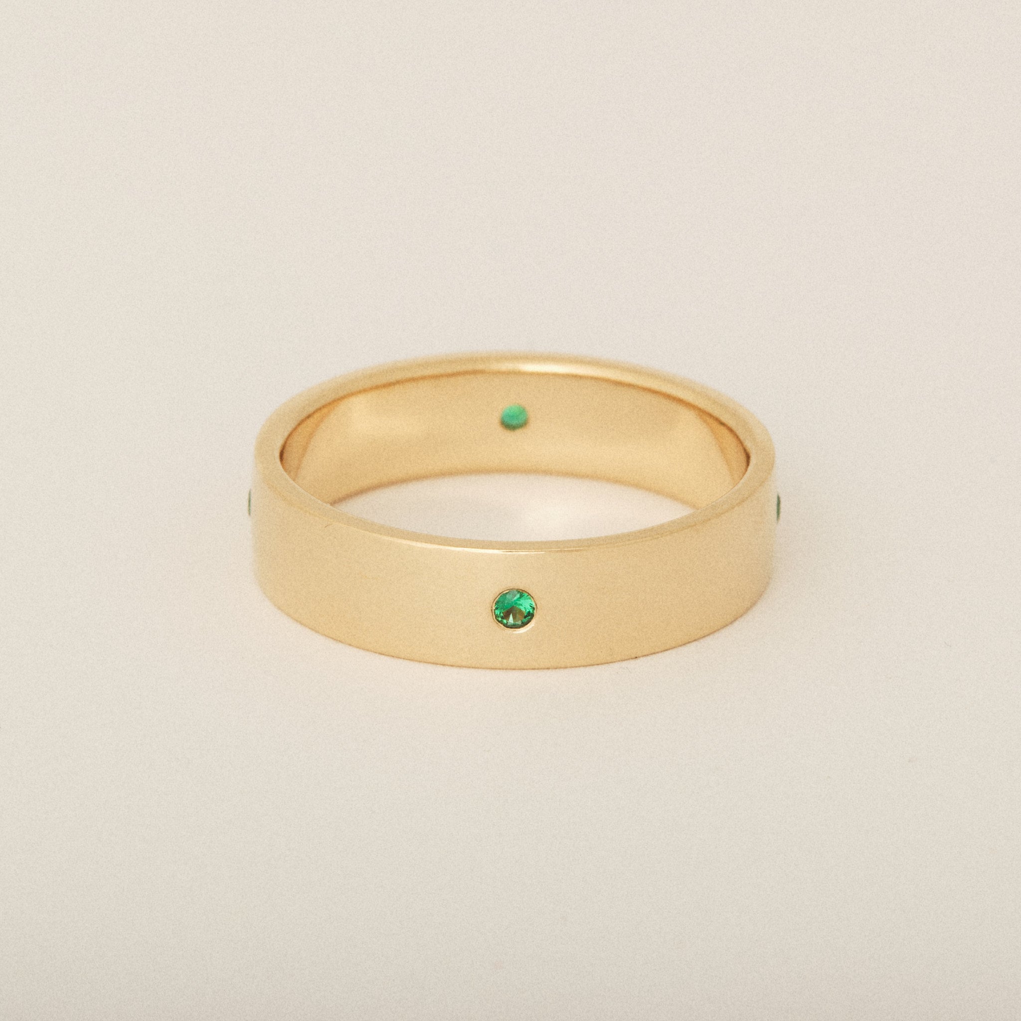Men's Wedding Band with Four Round Emeralds Flush Set