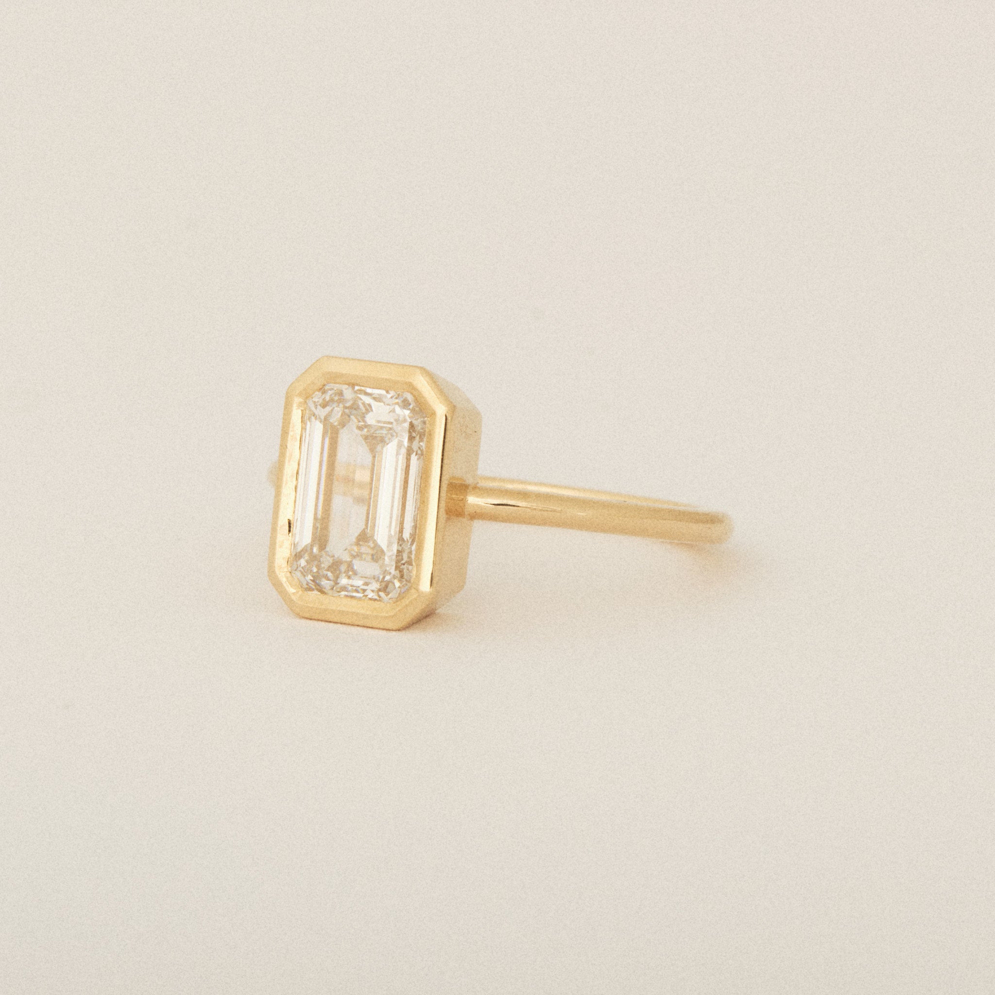 North South Emerald Cut Diamond Bezel Set Round Band 14k Yellow Gold Engagement Ring